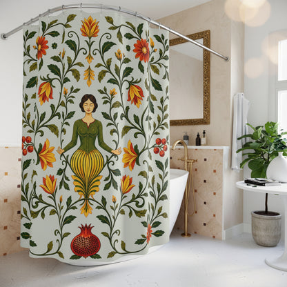 A floral shower curtain hanging in a bright white bathroom. The curtain features a central meditating woman surrounded by green vines, orange and red flowers, and a pomegranate at the bottom.